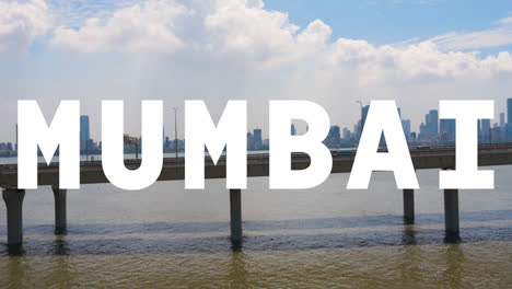 Drone-Shot-Of-Mumbai-City-Skyline-With-Bandra-Worli-Sea-Link-Bridge-Overlaid-With-Animated-Graphic-Spelling-Out-Mumbai